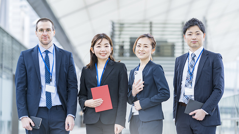 A business team of four men and women in suits